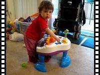 Running around and playing with her new toy piano